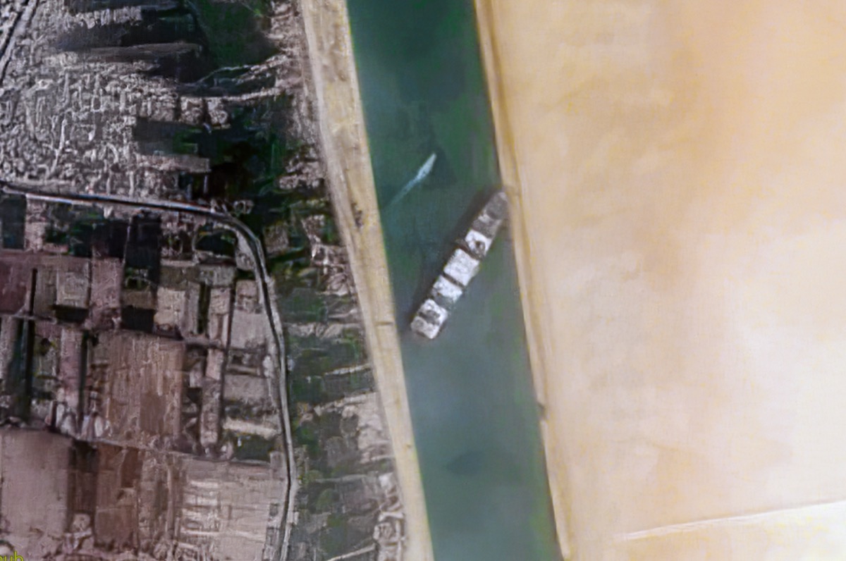 Cargo ship transiting narrow Suez Canal passage reminding chemical importers that single-point disruptions compound freight volatility