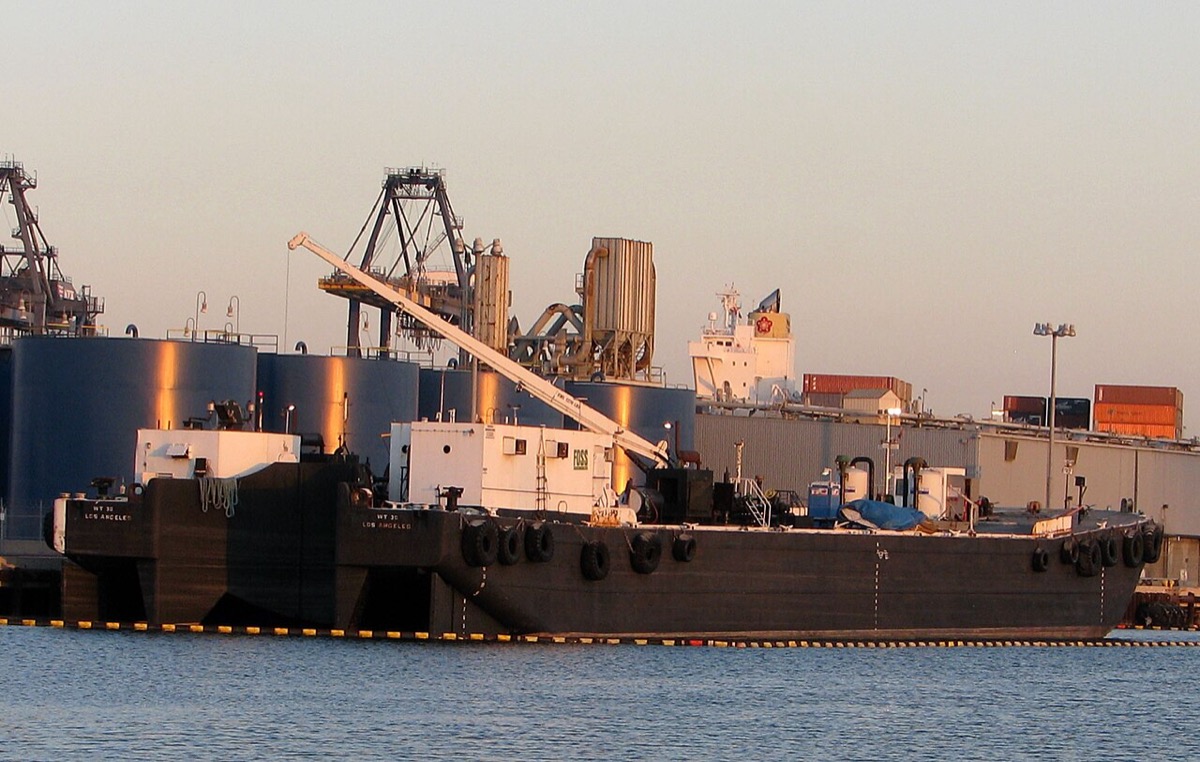 Aerial view of Port of Los Angeles with stacked containers and berthed vessels illustrating cyclical capacity dynamics