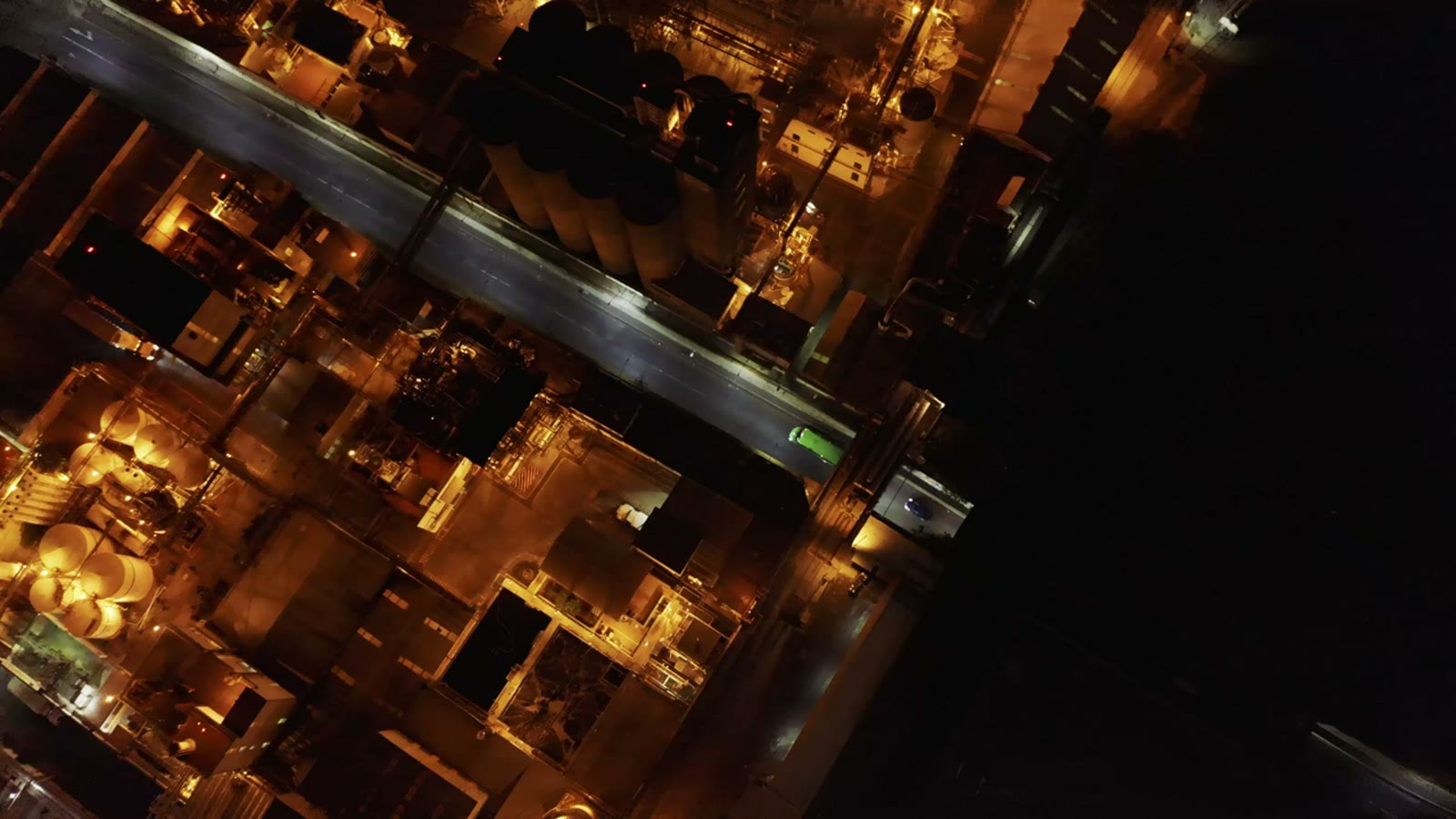 Factory roofs at night, seen from the air.